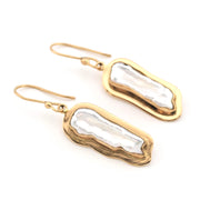 Gold earrings with pearl on a white background