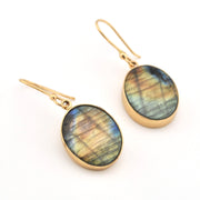 Gold earrings with Labradorite stones on a white background