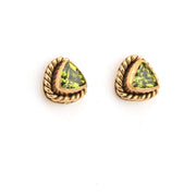 Gold-trimmed green gemstone earrings on a white background
