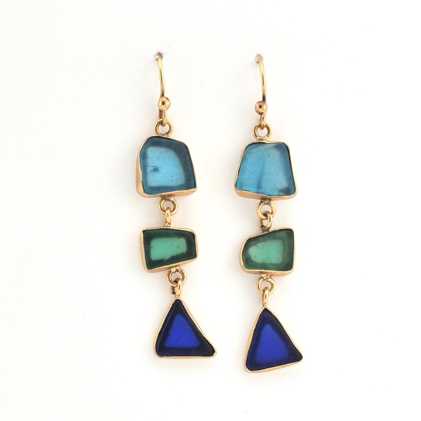 Pair of earrings with blue and green triangular stones on a white background