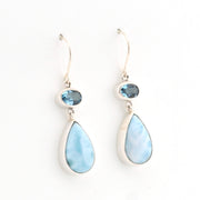 Teardrop-shaped earrings with blue gemstones on a white background