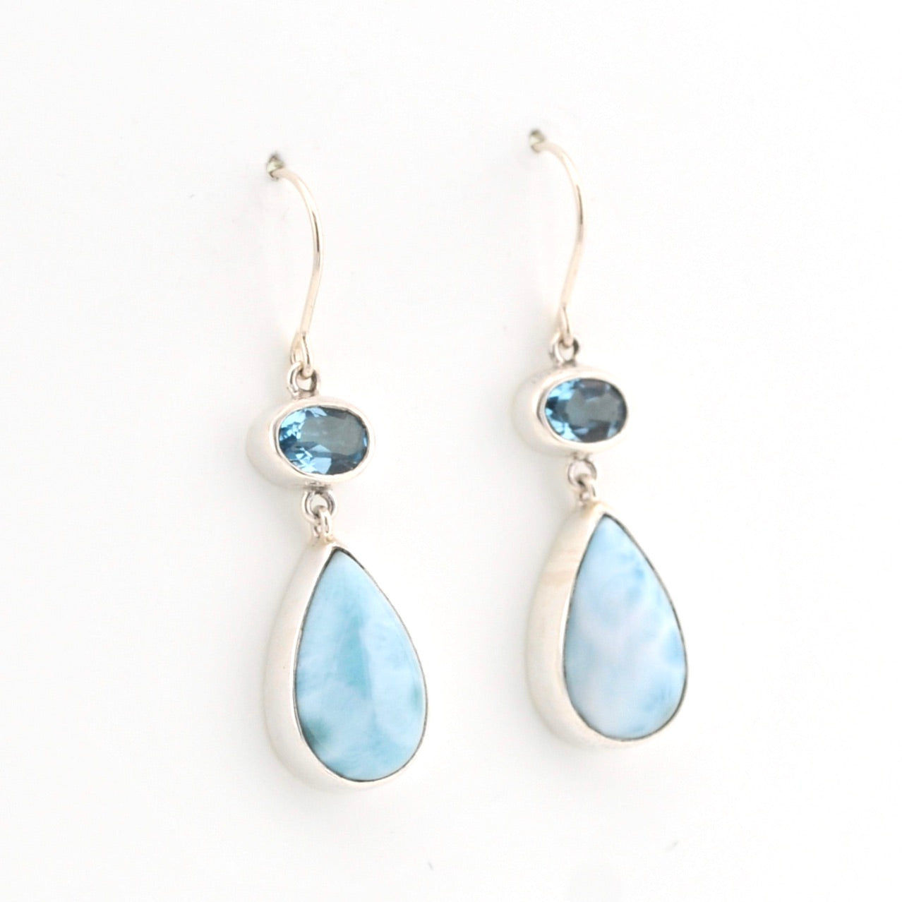 Teardrop-shaped earrings with blue gemstones on a white background