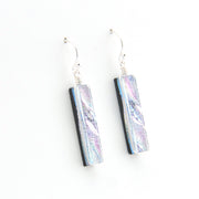 Pair of earrings with rectangular, iridescent glass on a white background