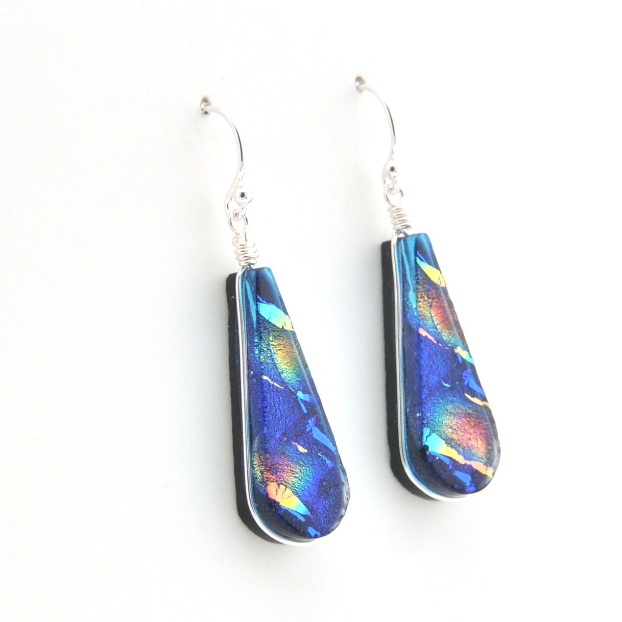 Teardrop-shaped earrings with colorful iridescent finish on a white background