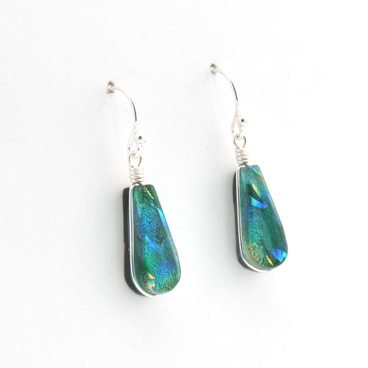 Teardrop-shaped earrings with iridescent green and blue stones on a white background