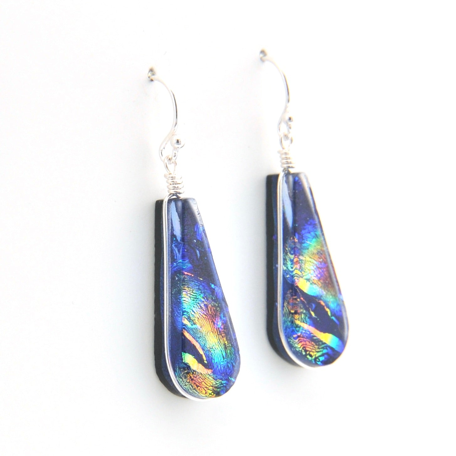 Teardrop-shaped earrings with colorful iridescent finish on a white background