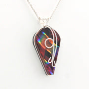 Multicolored pendant with a silver chain on a white background