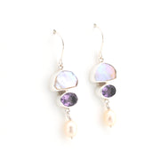 Pair of earrings with multicolored gemstones on a white background