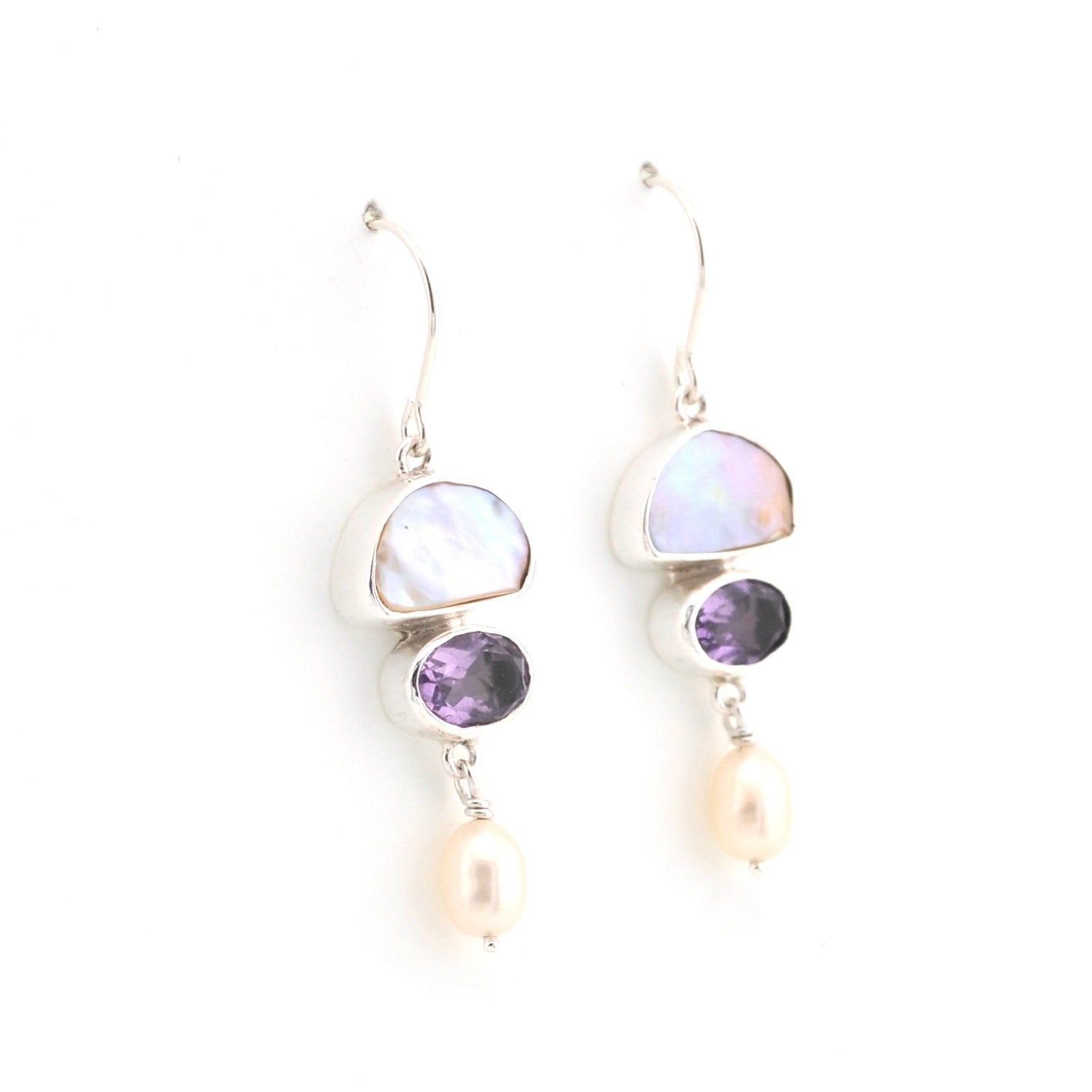 Pair of earrings with multicolored gemstones on a white background