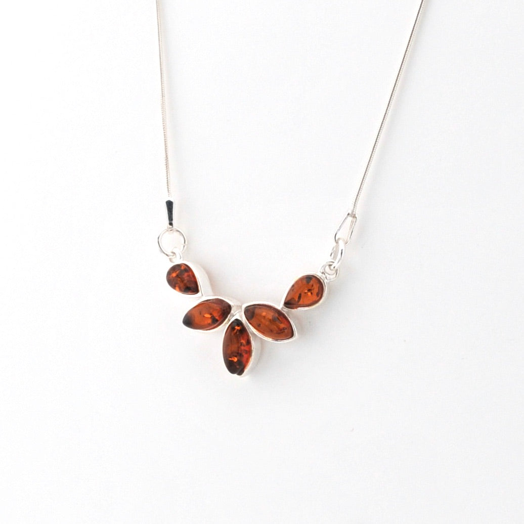 Necklace with amber-colored leaf pendants on a white background