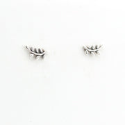 Pair of silver leaf-shaped earrings on a white background