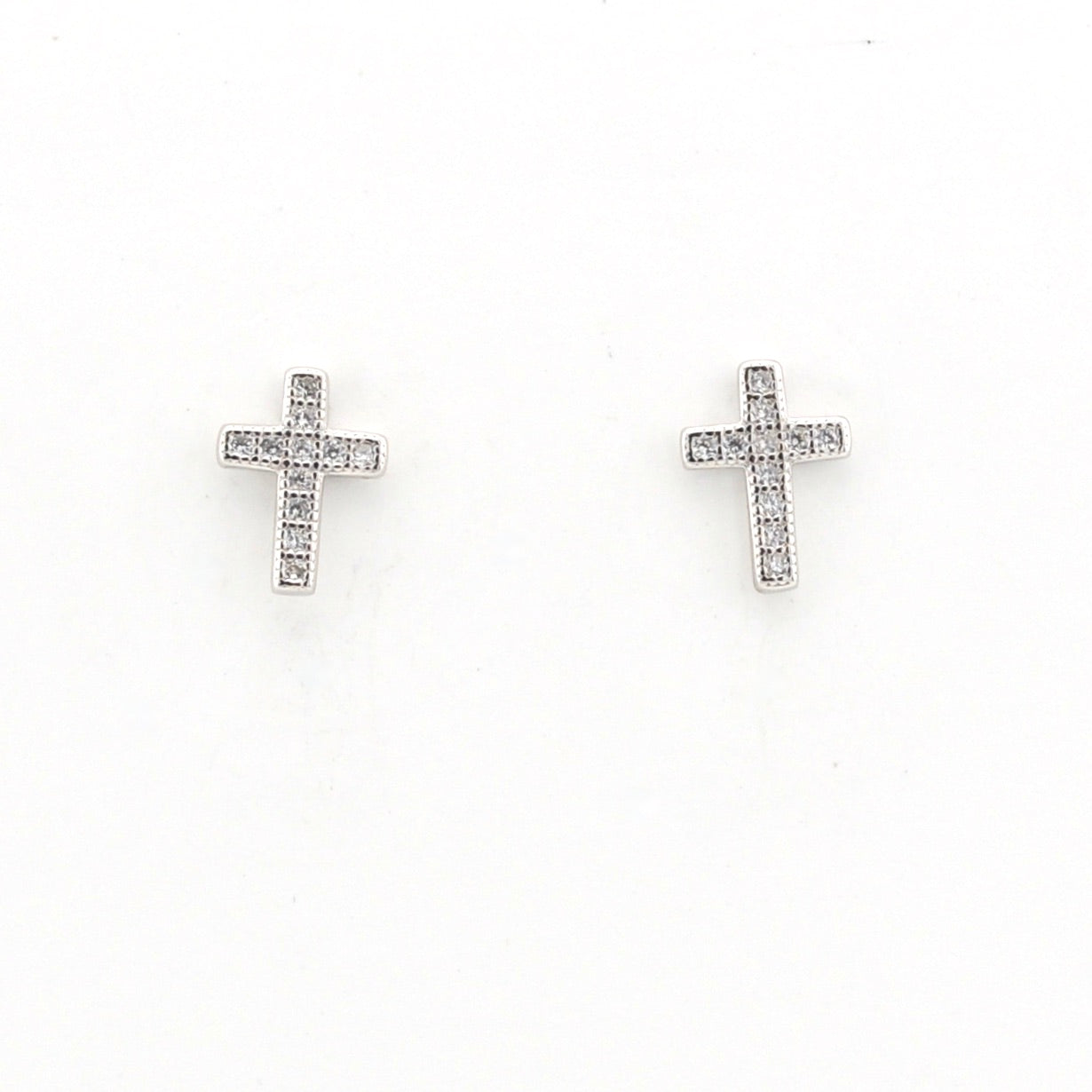 Pair of cross-shaped earrings on a white background