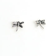 Pair of silver dragonfly-shaped earrings on a white background