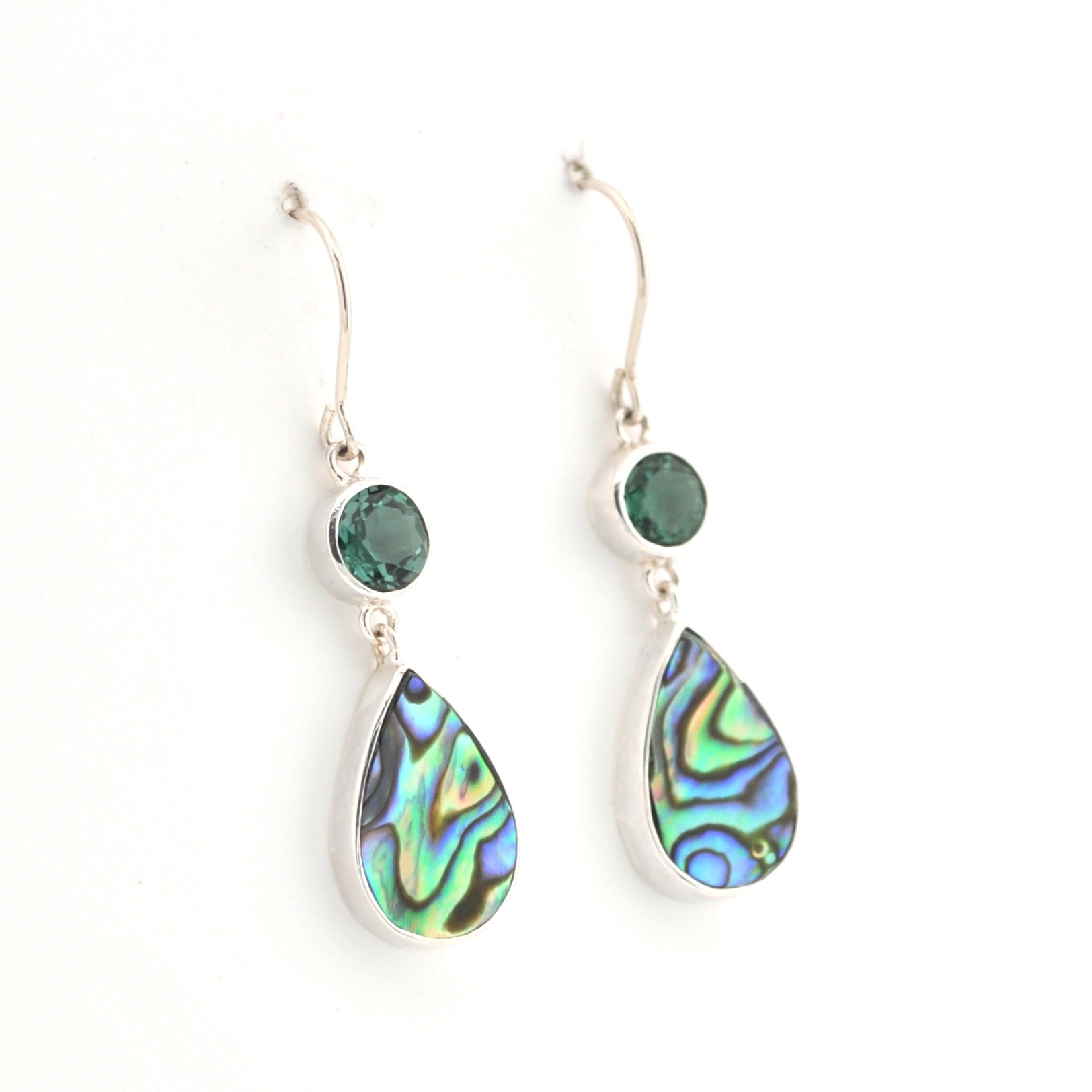 Teardrop-shaped earrings with green gemstones on a white background