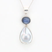 Necklace with a teardrop-shaped pearl and blue kyanite gemstone on a white background