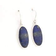 Pair of oval-shaped lapis lazuli earrings with silver frames on a white background