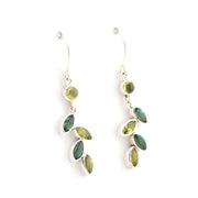 Pair of earrings with green gemstones on a white background