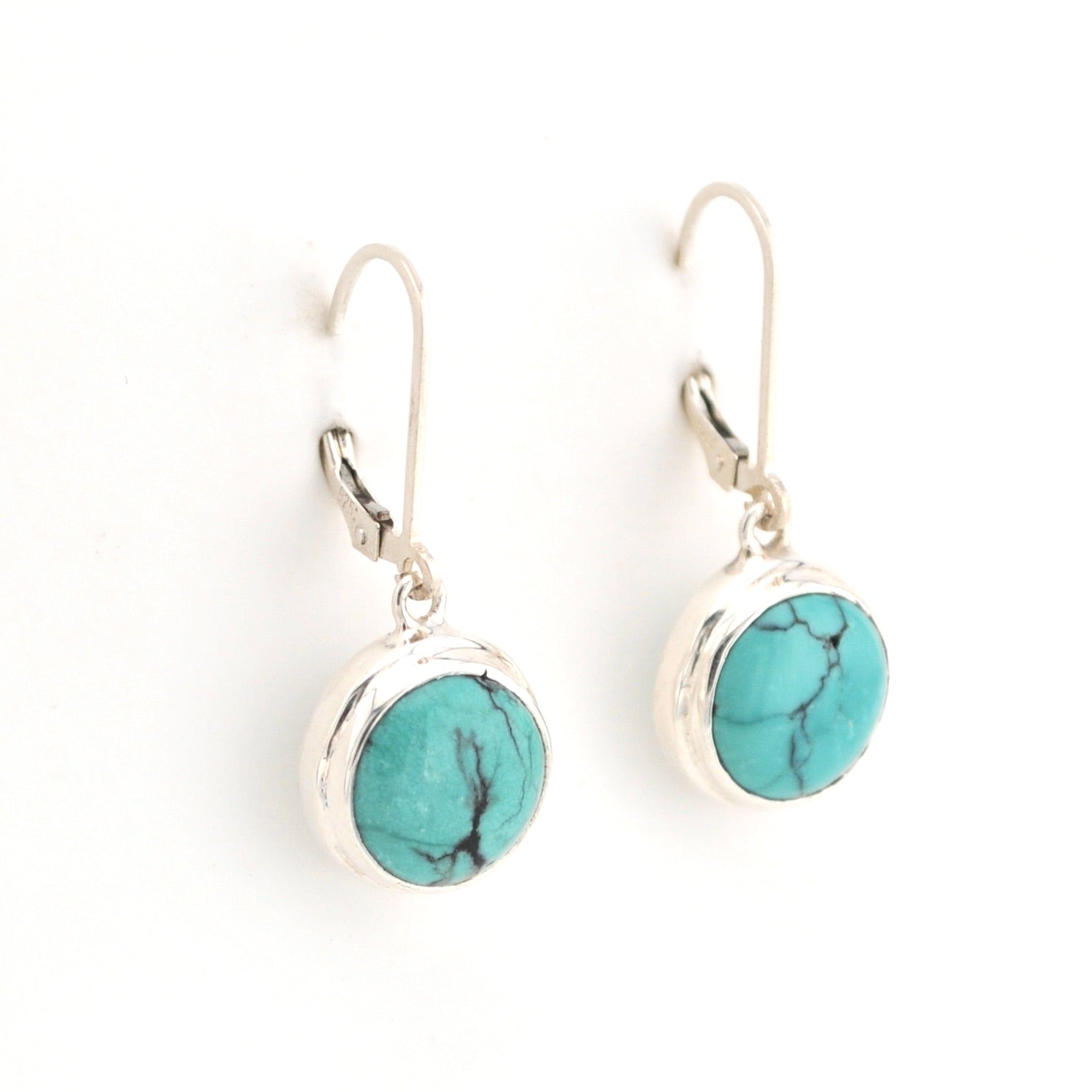 Turquoise stone earrings with silver hooks on a white background