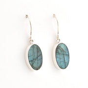 Silver earrings with blue Labradorite stones on a white background