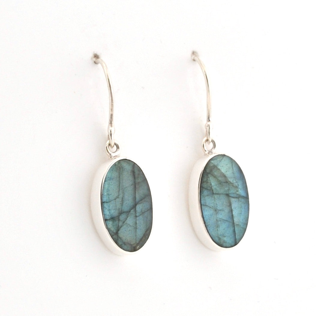Silver earrings with blue Labradorite stones on a white background