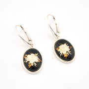 Pair of earrings with floral design on a white background