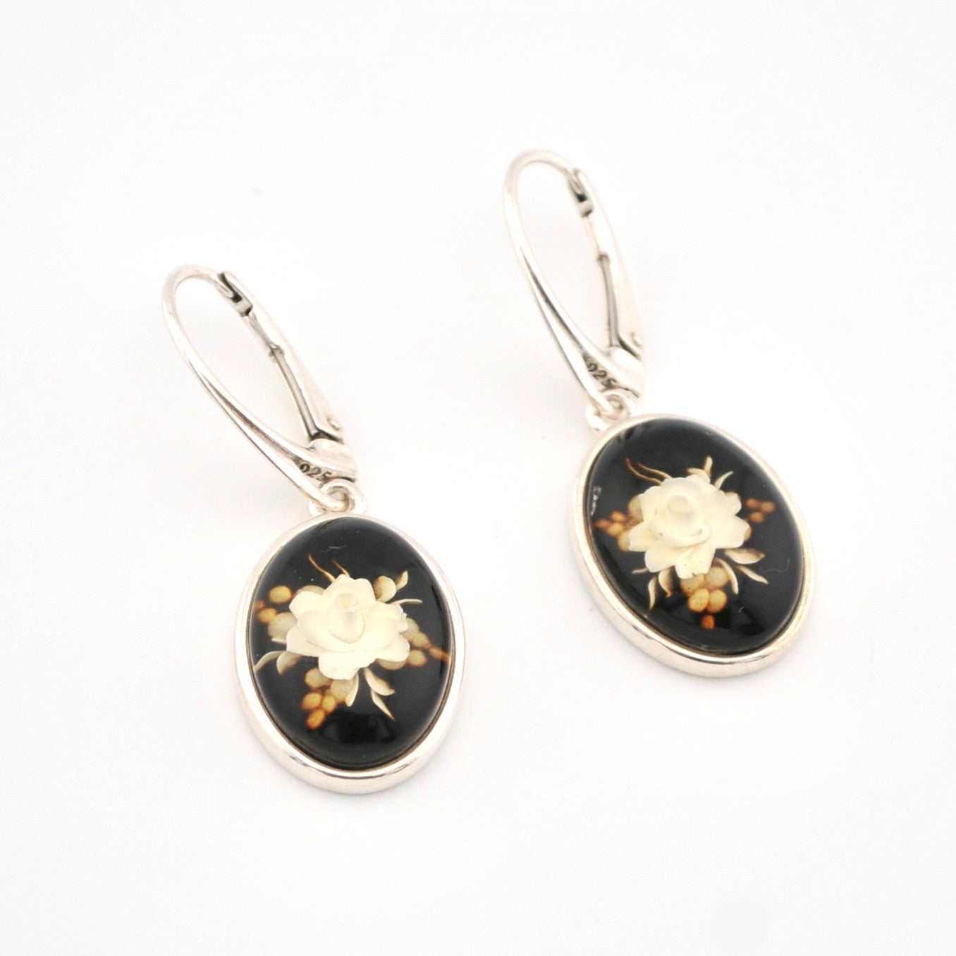 Pair of earrings with floral design on a white background