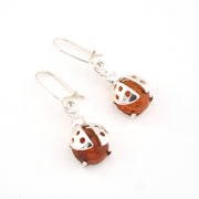 Silver and brown ladybug earrings on a white background
