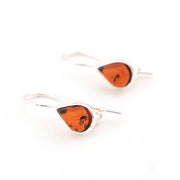 Pair of amber teardrop earrings on a white background