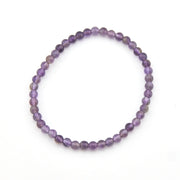 Purple beaded bracelet on a white background