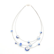 Necklace with blue and clear circle beads on a white background