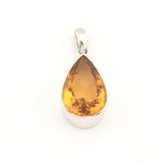Teardrop-shaped citrine pendant on a white background