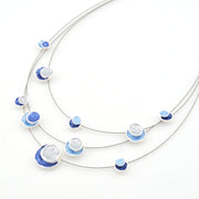 Necklace with blue and white circular pendants on a white background