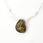 Necklace with a large, oval-shaped pendant on a white background