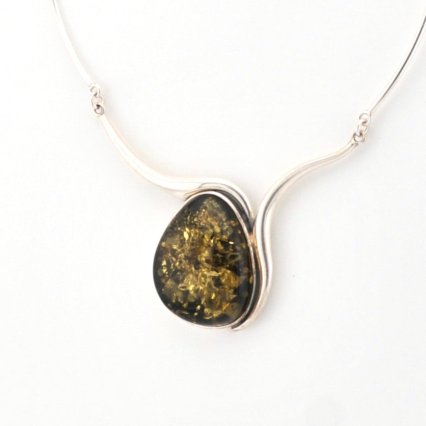 Necklace with a large, oval-shaped pendant on a white background