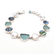 Bracelet with green and silver beads on a white background