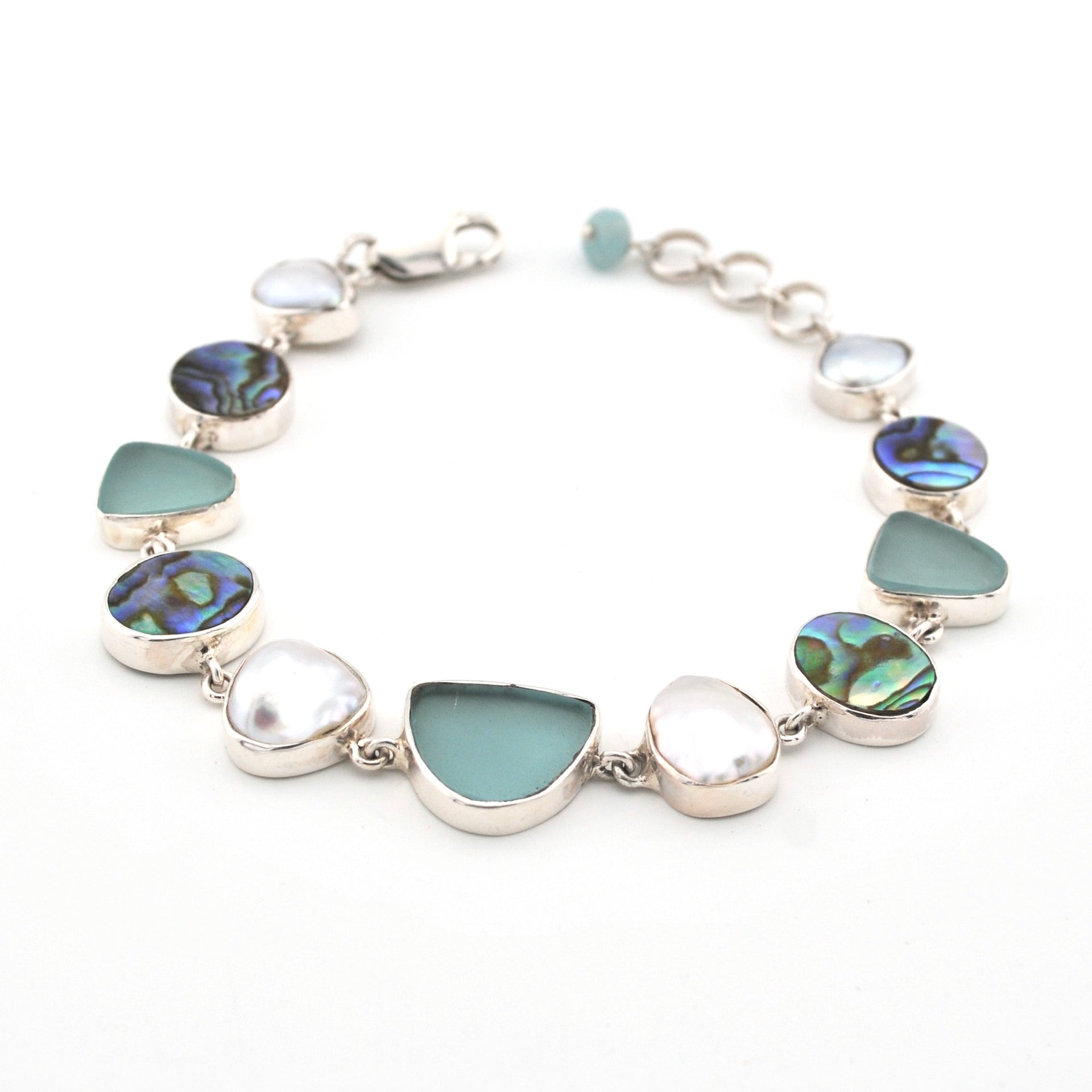 Bracelet with green and silver beads on a white background