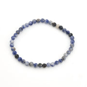 Beaded bracelet with blue and black beads on a white background