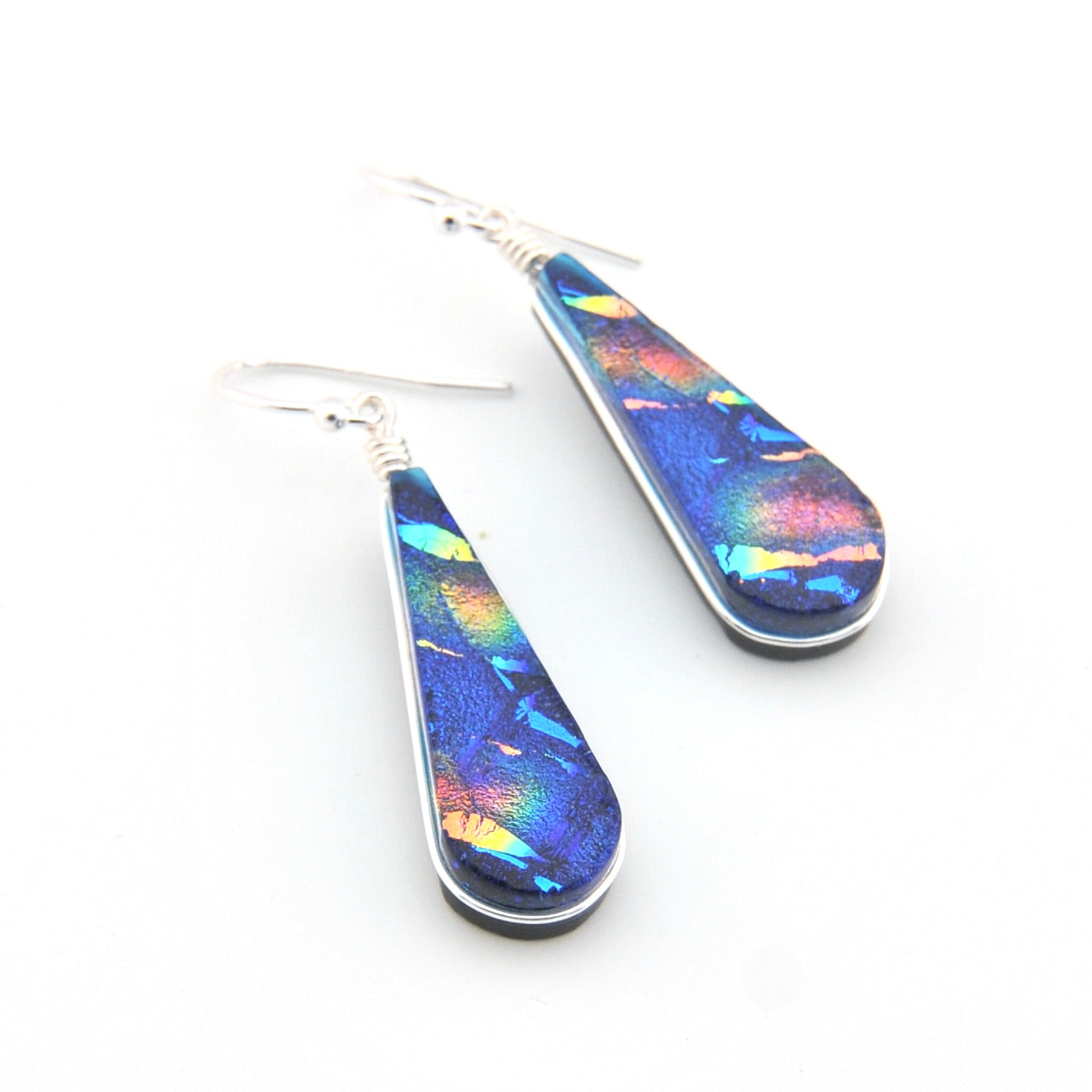 Teardrop-shaped earrings with colorful iridescent finish on a white background