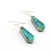Teal and silver earrings on a white background