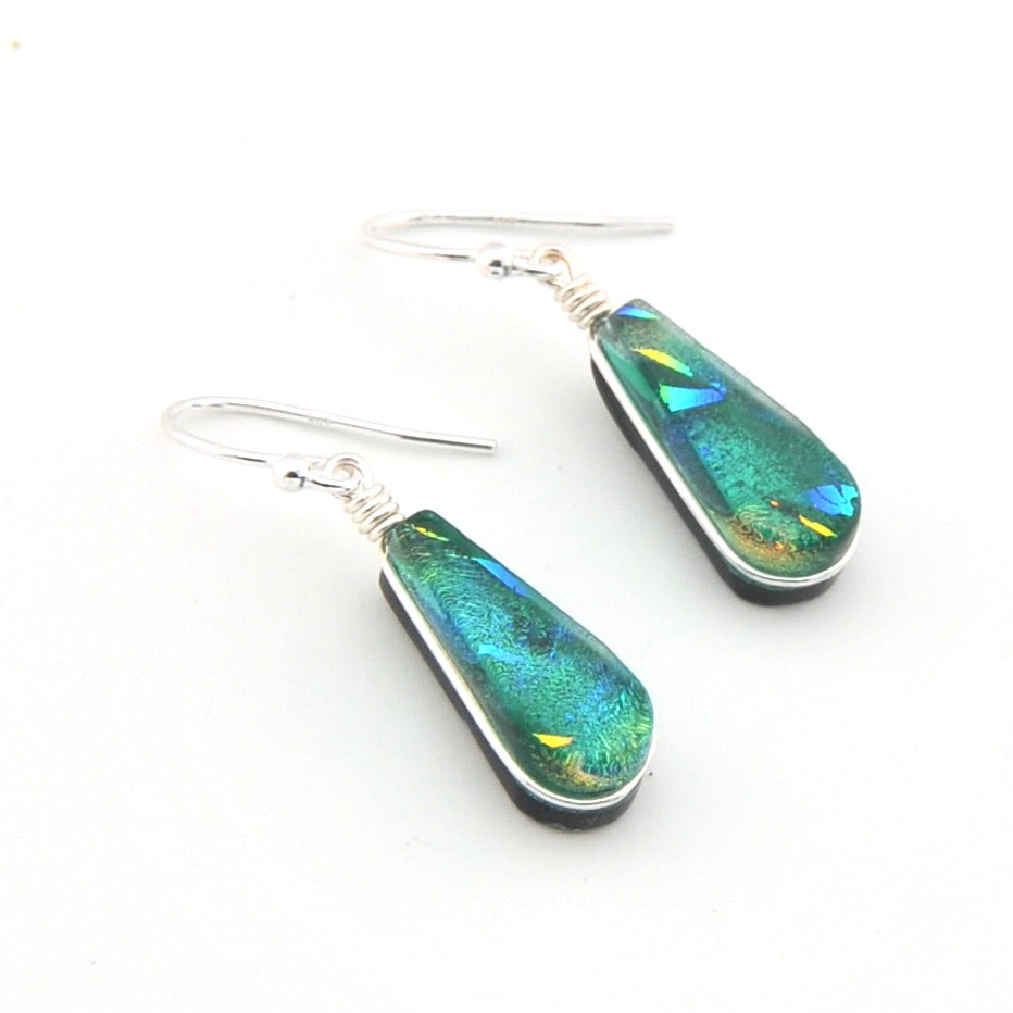 Teal and silver earrings on a white background