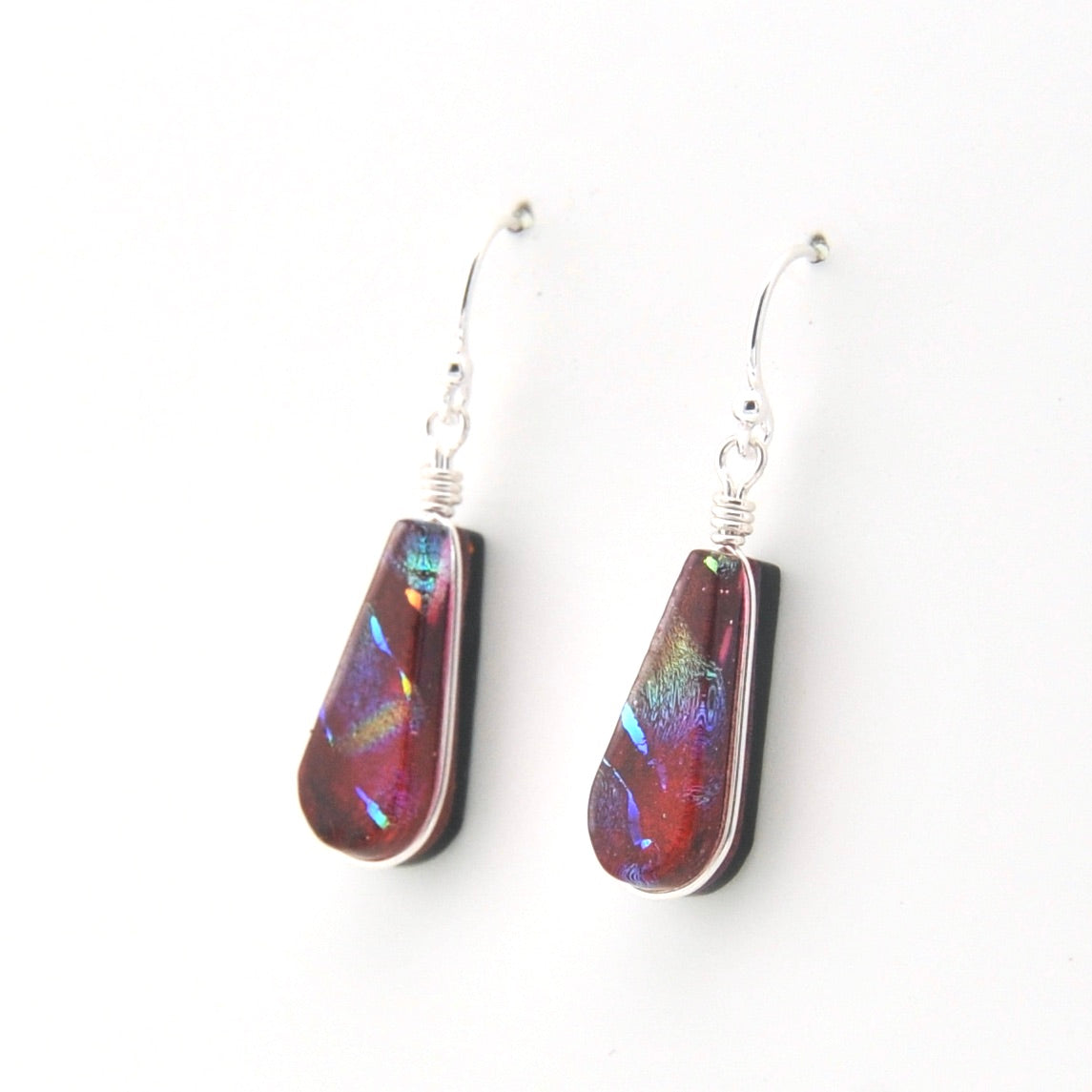 Teardrop-shaped earrings with colorful iridescent finish on a white background