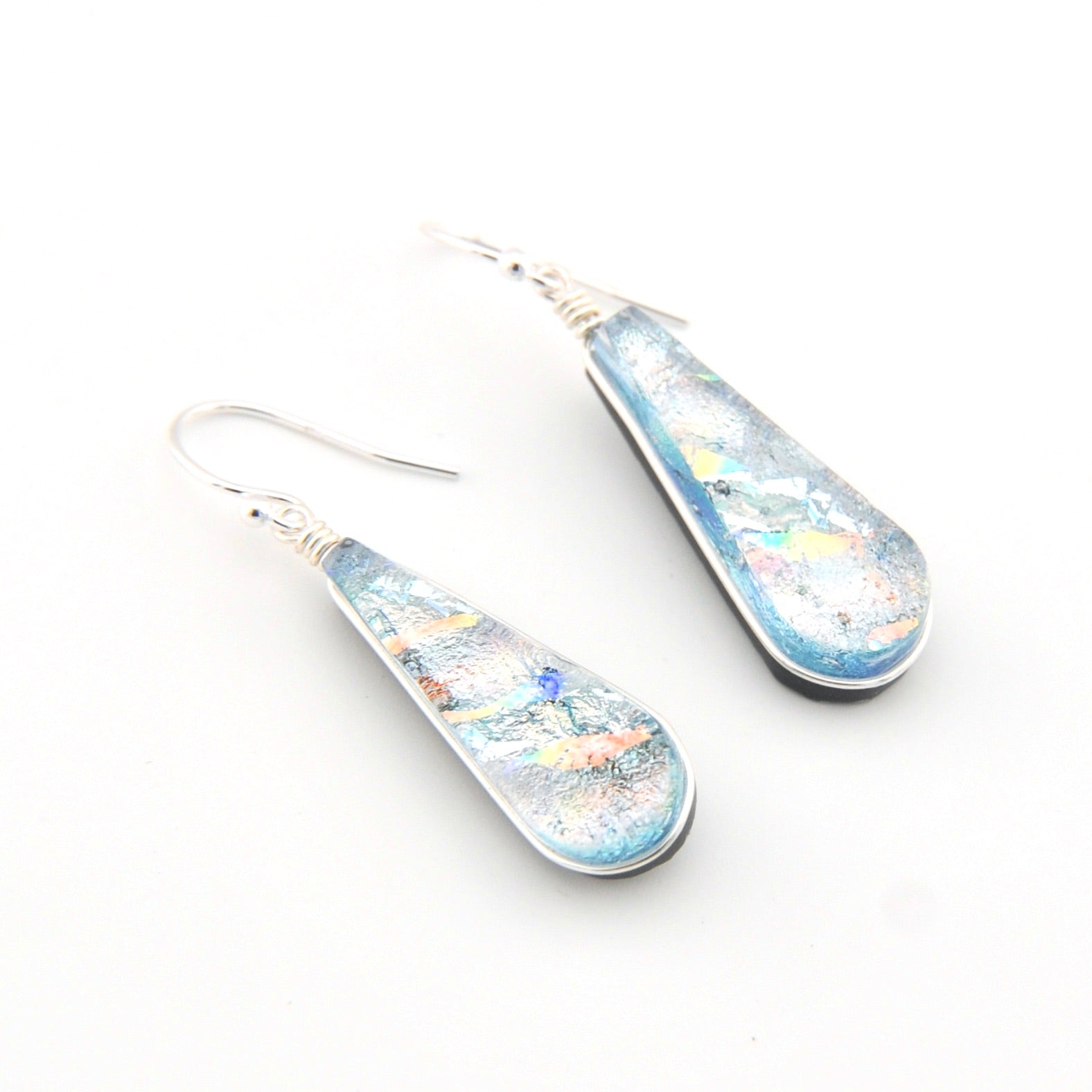 Teardrop-shaped earrings with a multicolored design on a white background