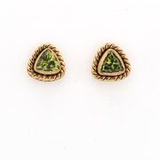 Pair of gold-trimmed green gemstone earrings on a white background