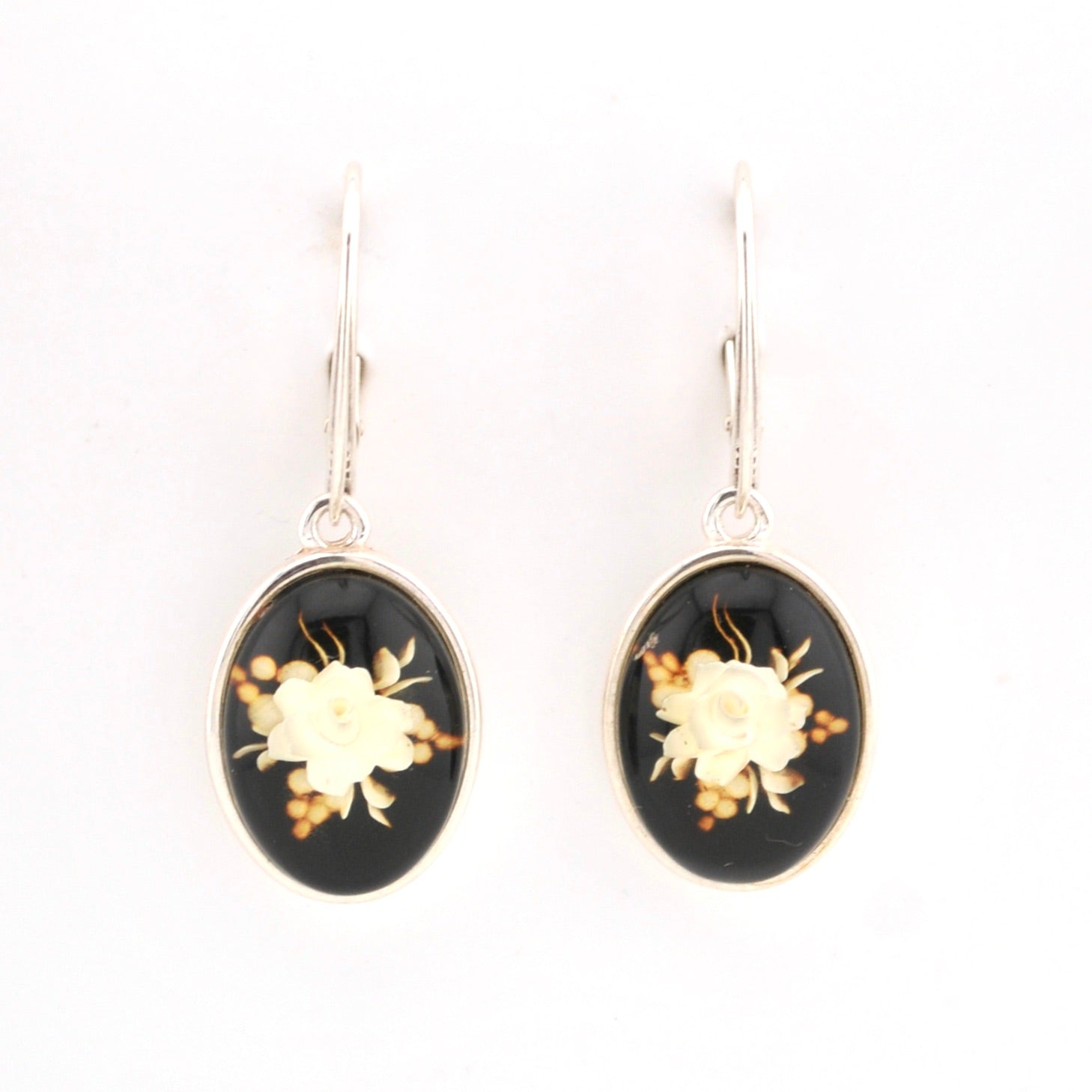 Pair of earrings with floral design on a white background