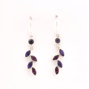 Pair of purple gemstone earrings on a white background