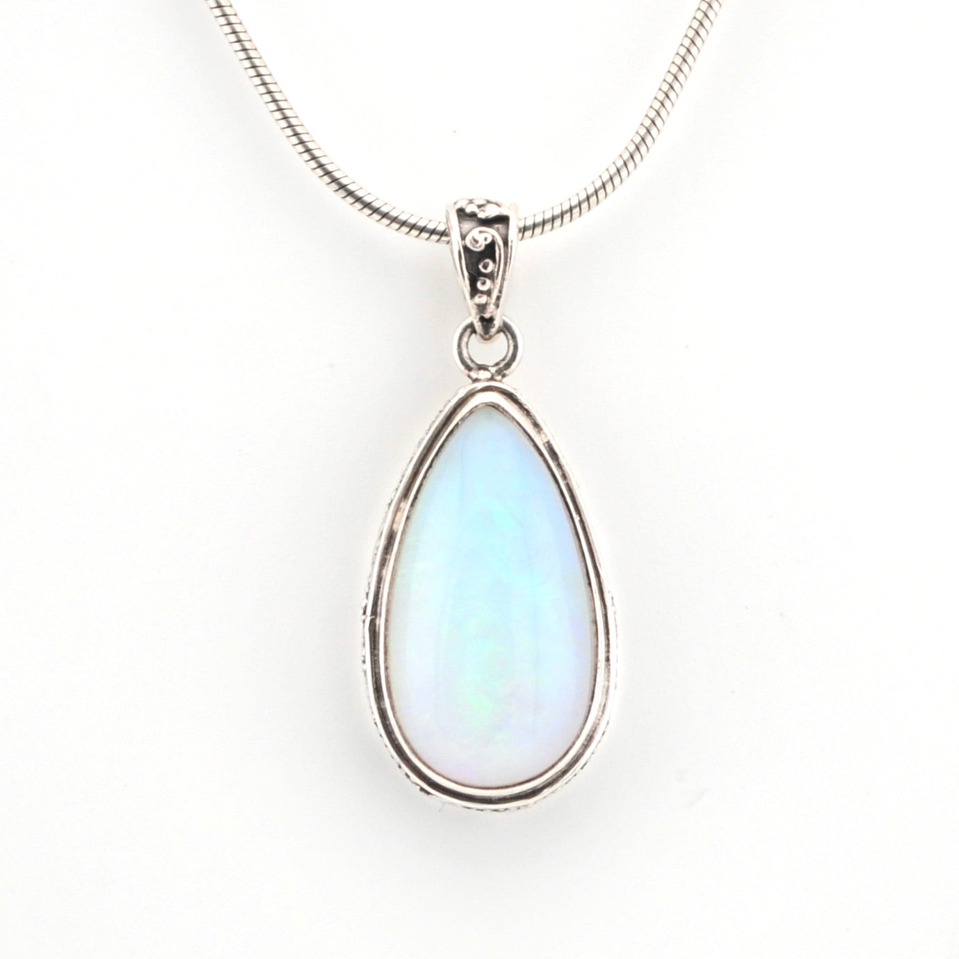 Teardrop-shaped pendant with a light blue gemstone on a white background