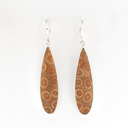 Pair of earrings with brown floral patterns on a white background