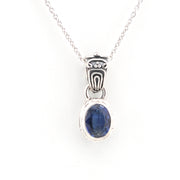 Silver pendant with a blue gemstone on a white background