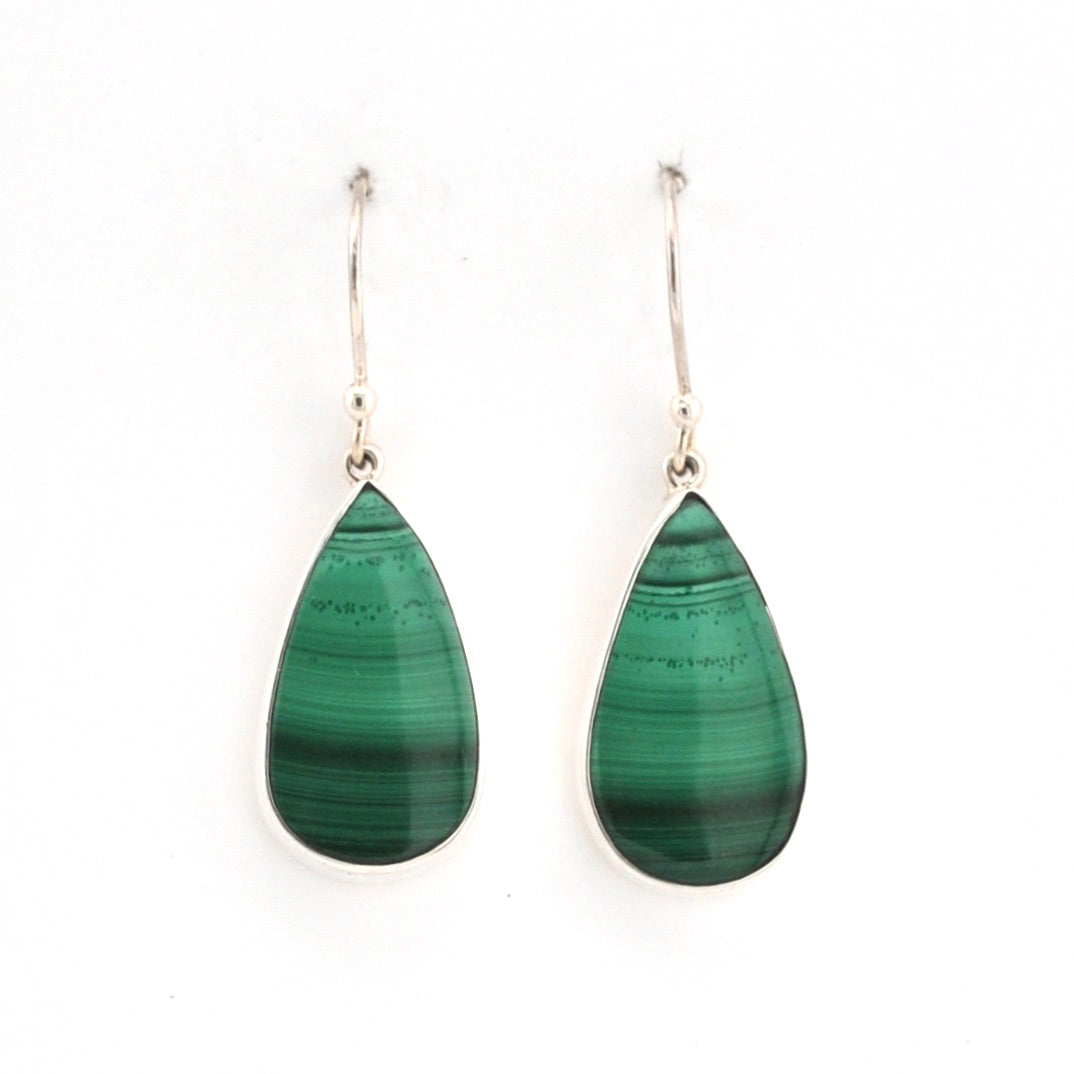 Teardrop-shaped green earrings on a white background