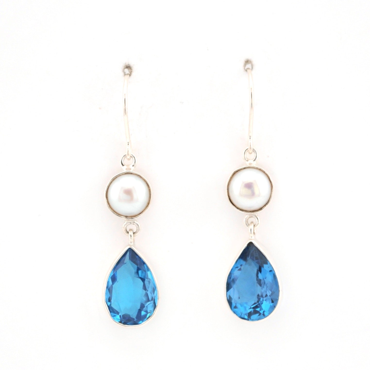 Pair of earrings with blue teardrop-shaped gemstones and pearl on a white background